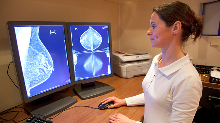 Woman looking at breast cancer scans