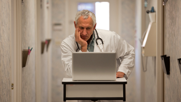 Doctor looking at a computer.