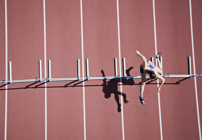 Runner jumping hurdles