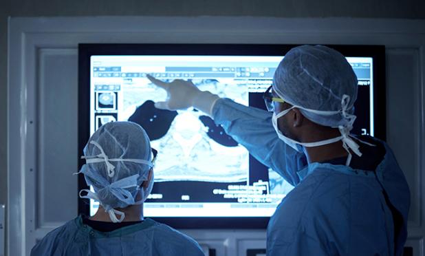 Surgeons looking at digital xray images